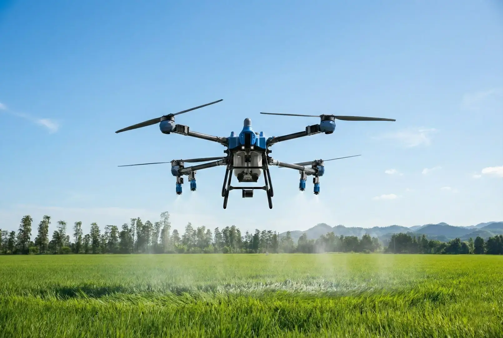 Heavy-lift industrial spraying drone performing precision spraying in a sunny field.